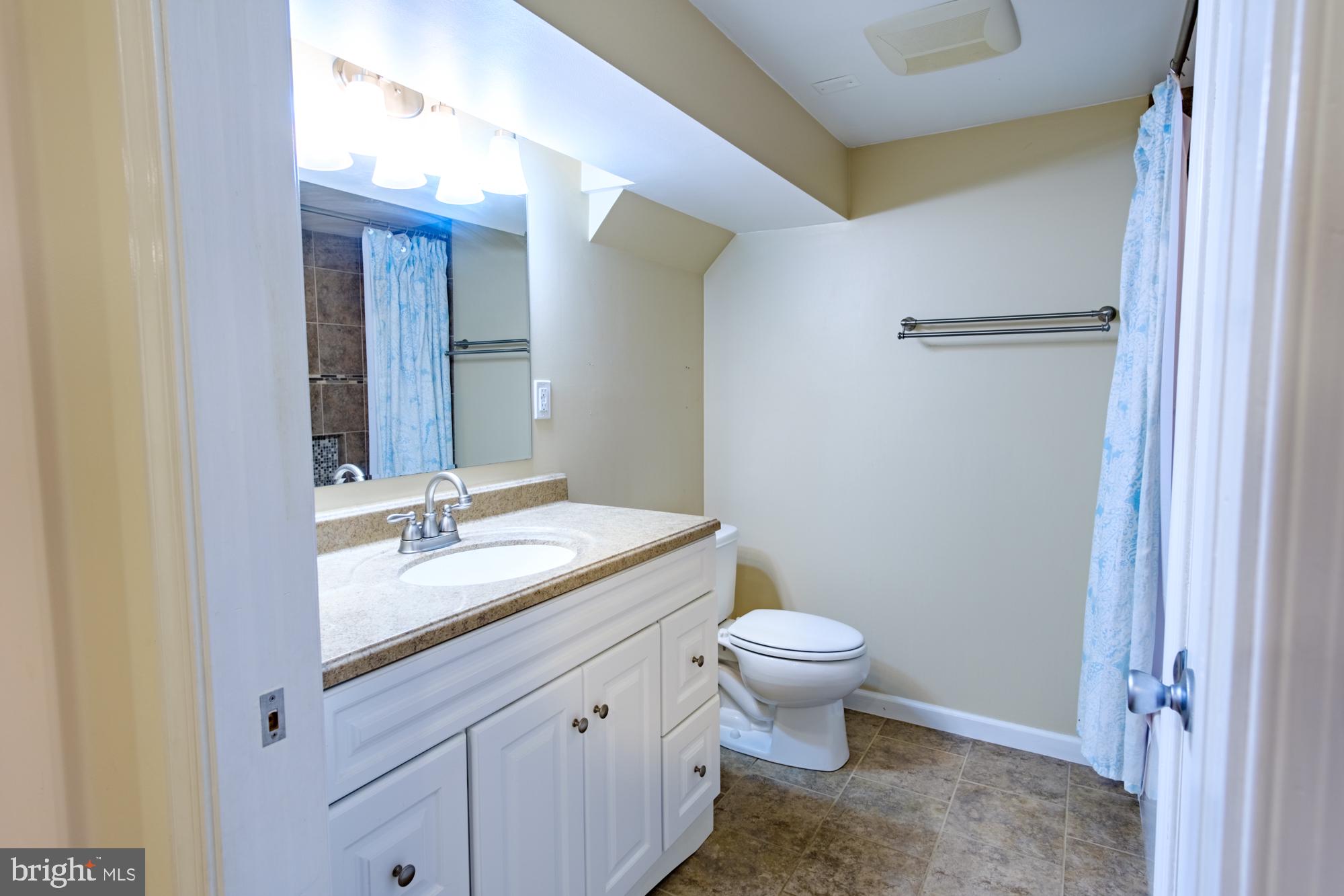 8501 Pleasant Plains Road Baltimore, MD 21286 - Photo 38 of 53 a bathroom with a granite countertop sink toilet and mirror