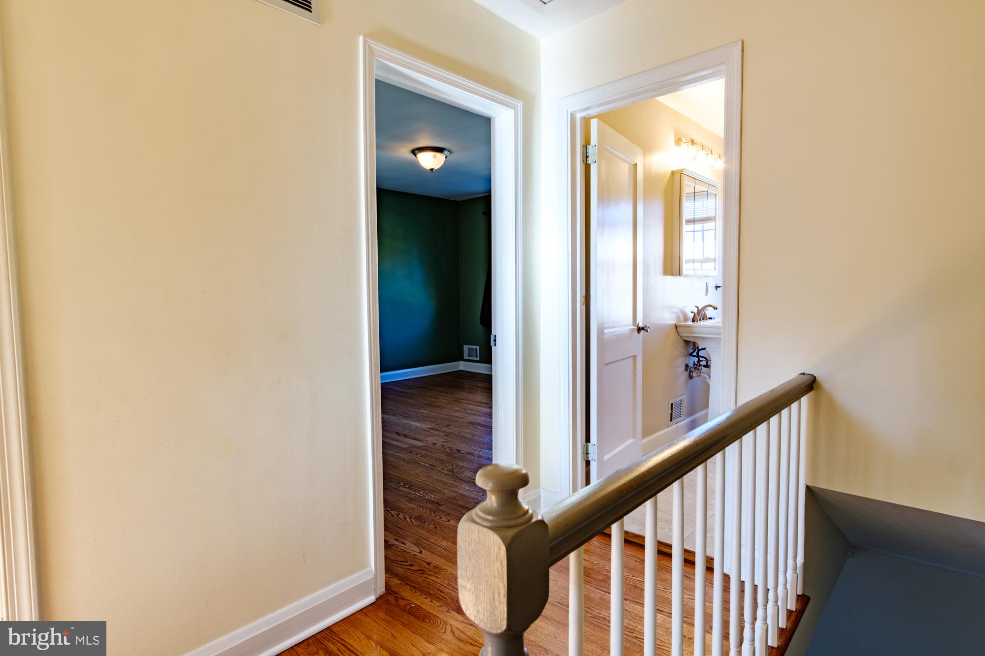 8501 Pleasant Plains Road Baltimore, MD 21286 - Photo 42 of 53 a view of a hallway with wooden floor and staircase