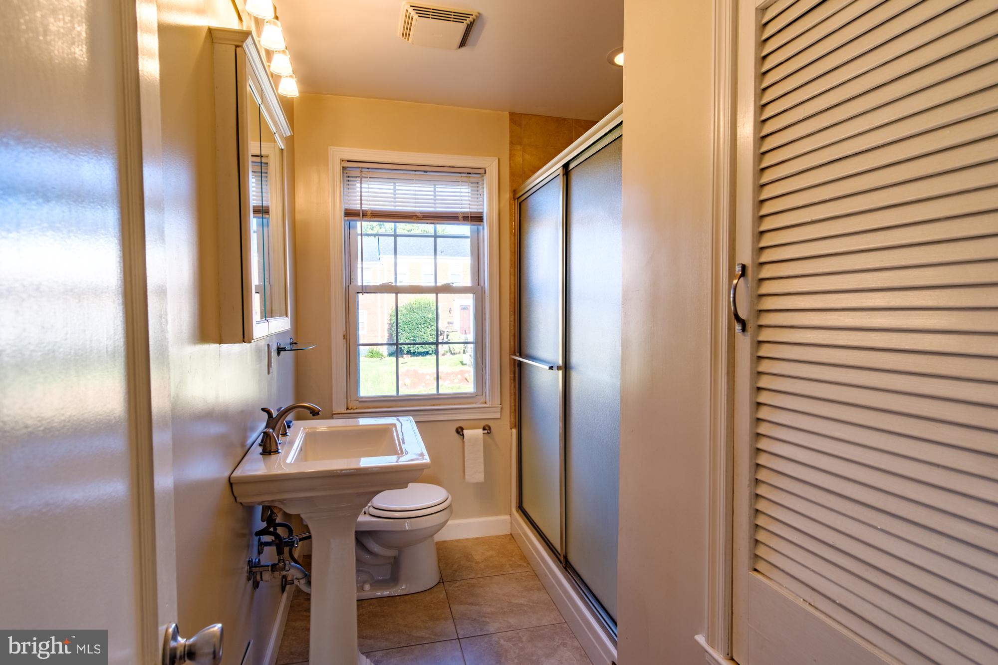 8501 Pleasant Plains Road Baltimore, MD 21286 - Photo 43 of 53 a bathroom with a sink a toilet and shower