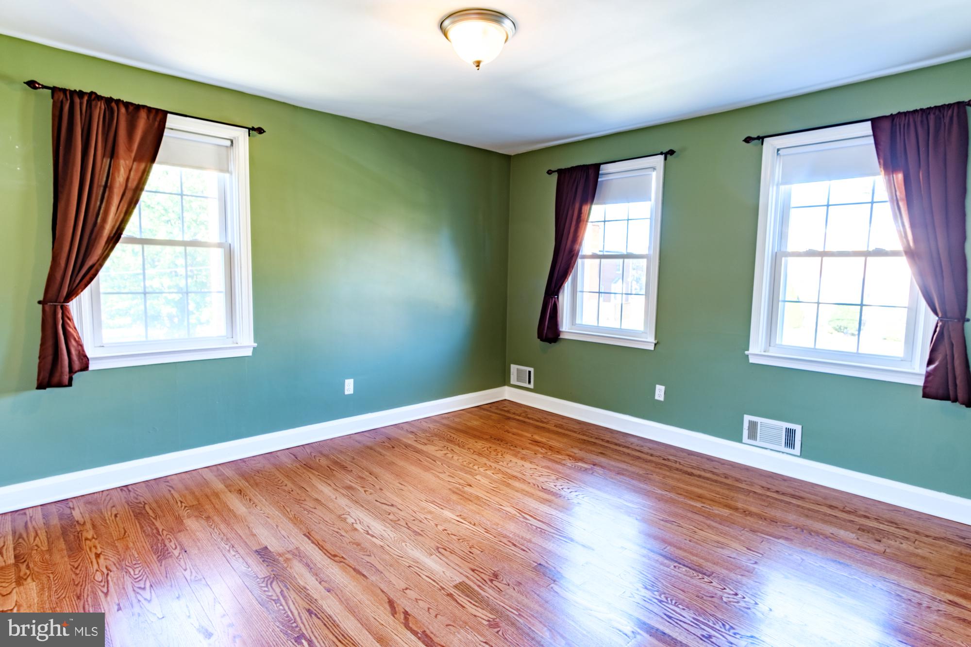 8501 Pleasant Plains Road Baltimore, MD 21286 - Photo 46 of 53 a view of an empty room with wooden floor and a window