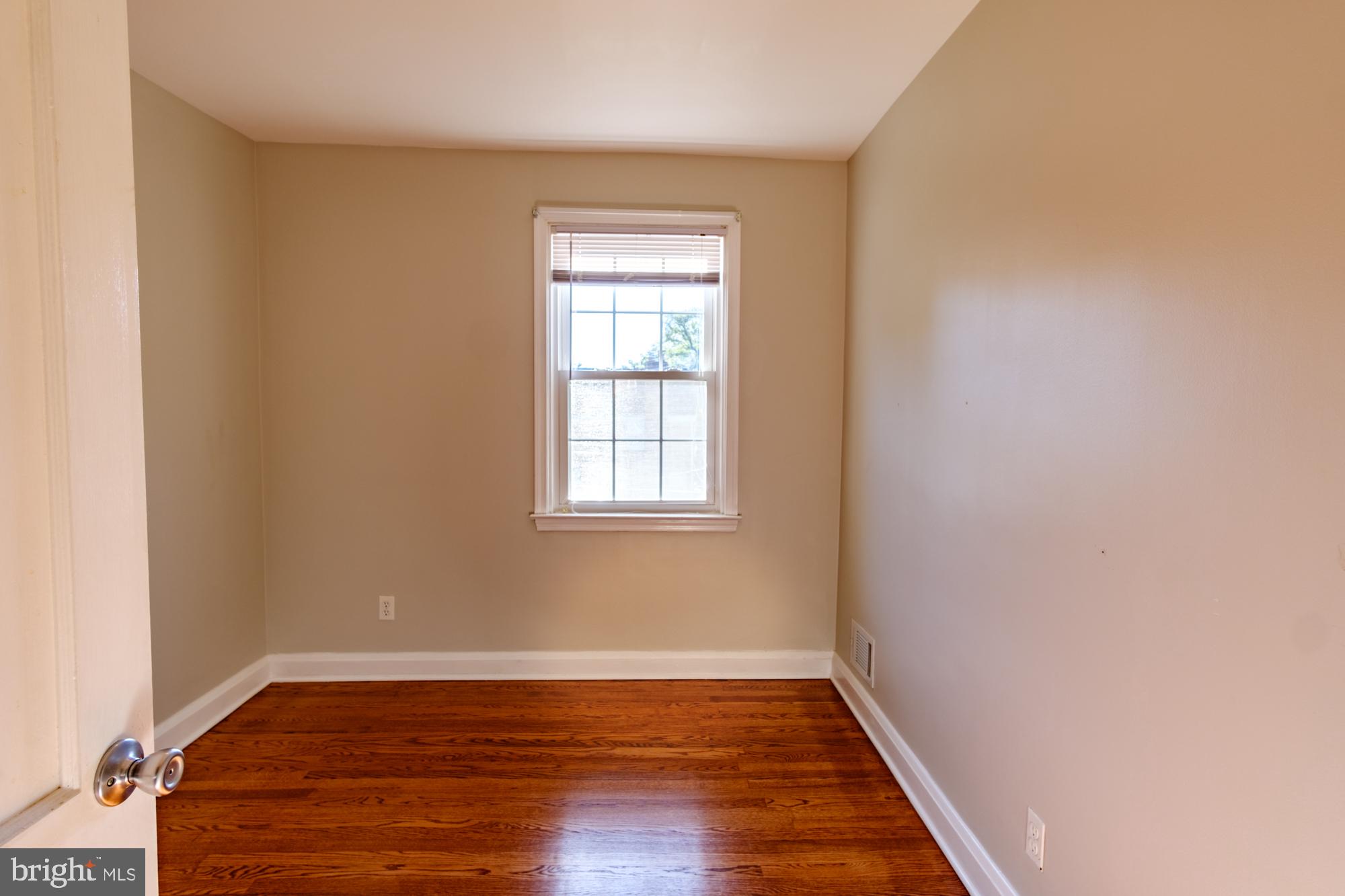 8501 Pleasant Plains Road Baltimore, MD 21286 - Photo 49 of 53 an empty room with wooden floor and windows