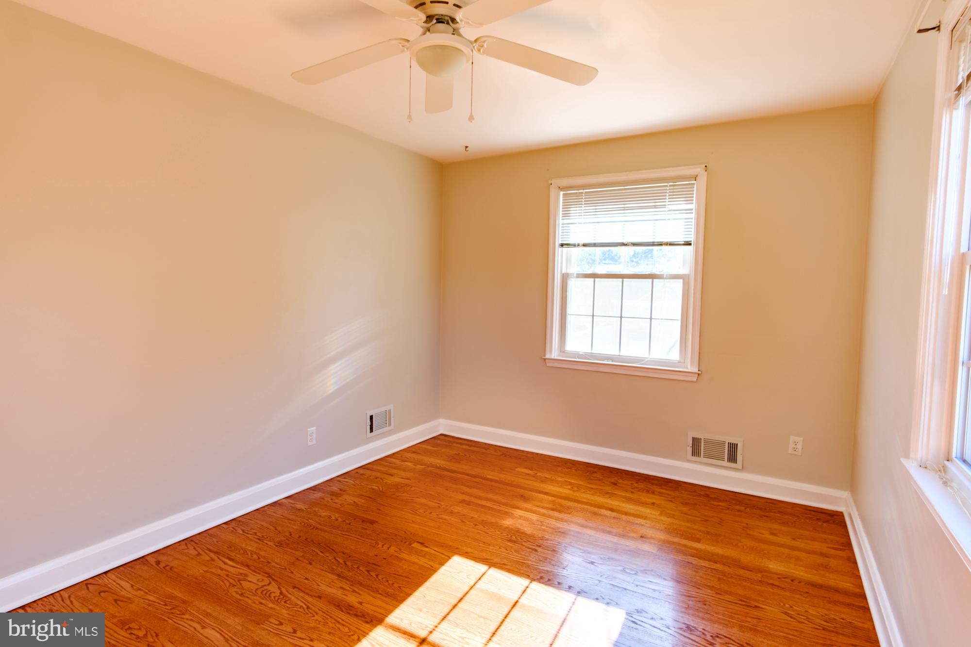 8501 Pleasant Plains Road Baltimore, MD 21286 - Photo 51 of 53 a view of empty room with wooden floor and fan
