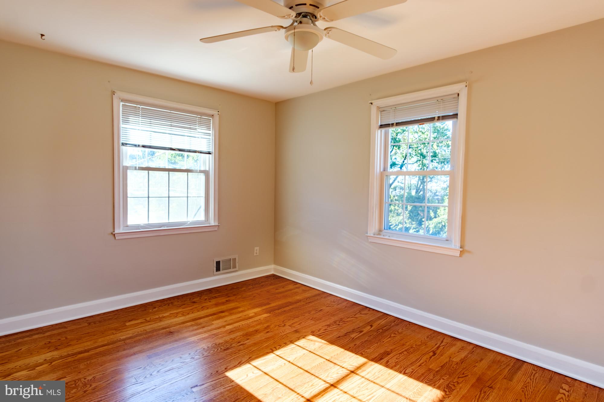 8501 Pleasant Plains Road Baltimore, MD 21286 - Photo 52 of 53 a view of empty room with wooden floor and fan