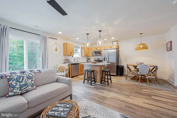 a living room with furniture and kitchen view