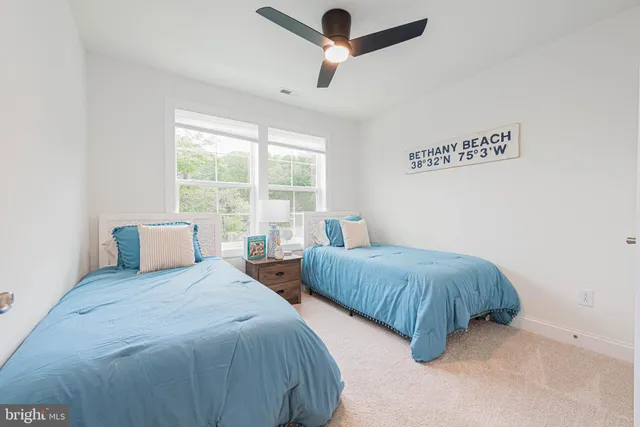 a bedroom with two beds and a chandelier