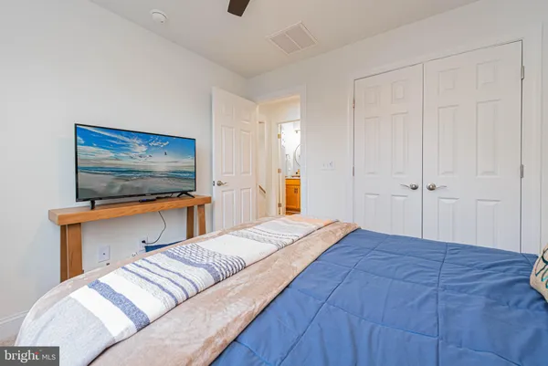 a bedroom with a bed and a flat screen tv