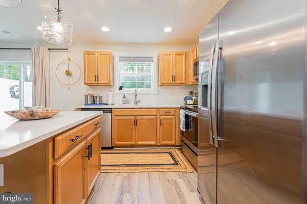 a kitchen with stainless steel appliances a sink stove and refrigerator