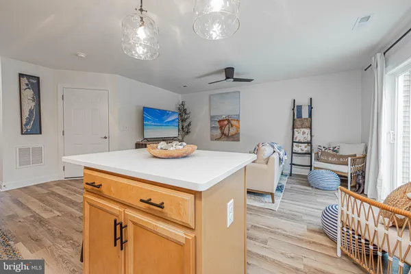a kitchen with a stove cabinets and wooden floor