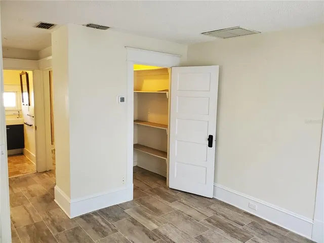 a living room with furniture a rug and white walls