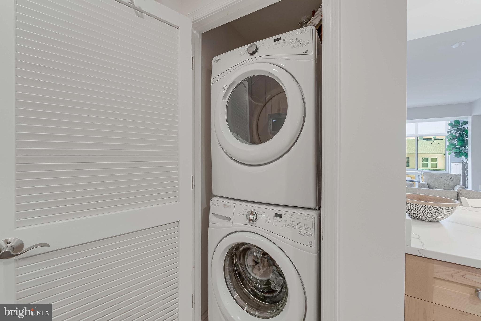 11990 Market Street, Unit 414 Reston, VA 20190 - Photo 20 of 52 a view of a hallway with washer and dryer