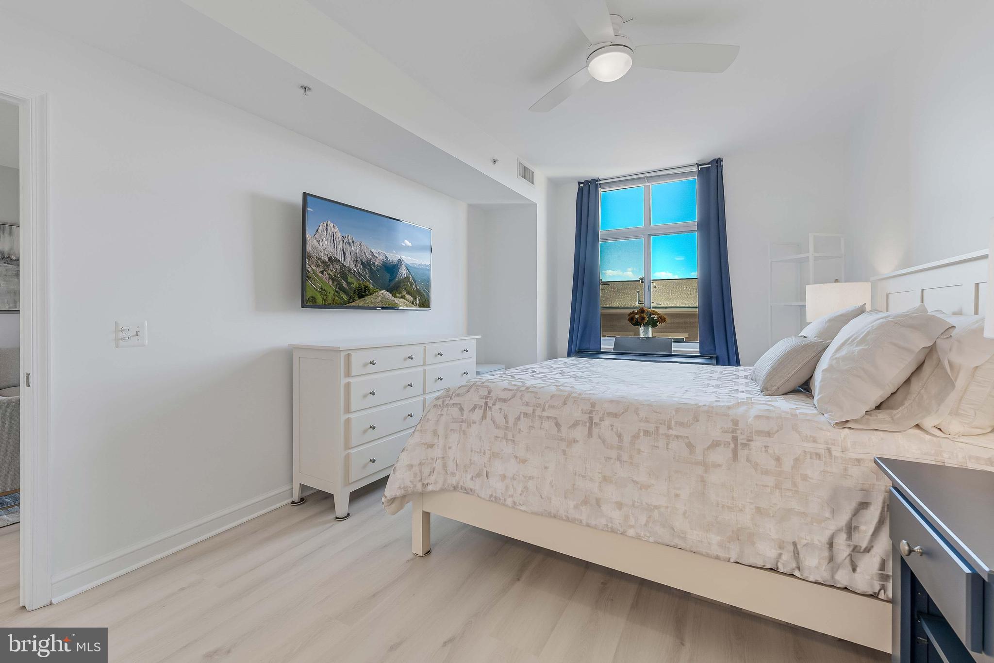 11990 Market Street, Unit 414 Reston, VA 20190 - Photo 25 of 52 a bedroom with a bed and a window