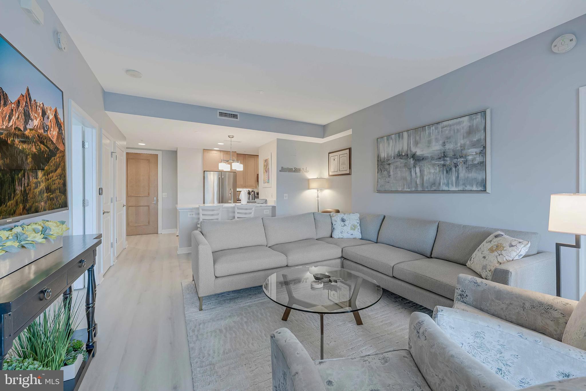 11990 Market Street, Unit 414 Reston, VA 20190 - Photo 3 of 52 a living room with furniture and a flat screen tv