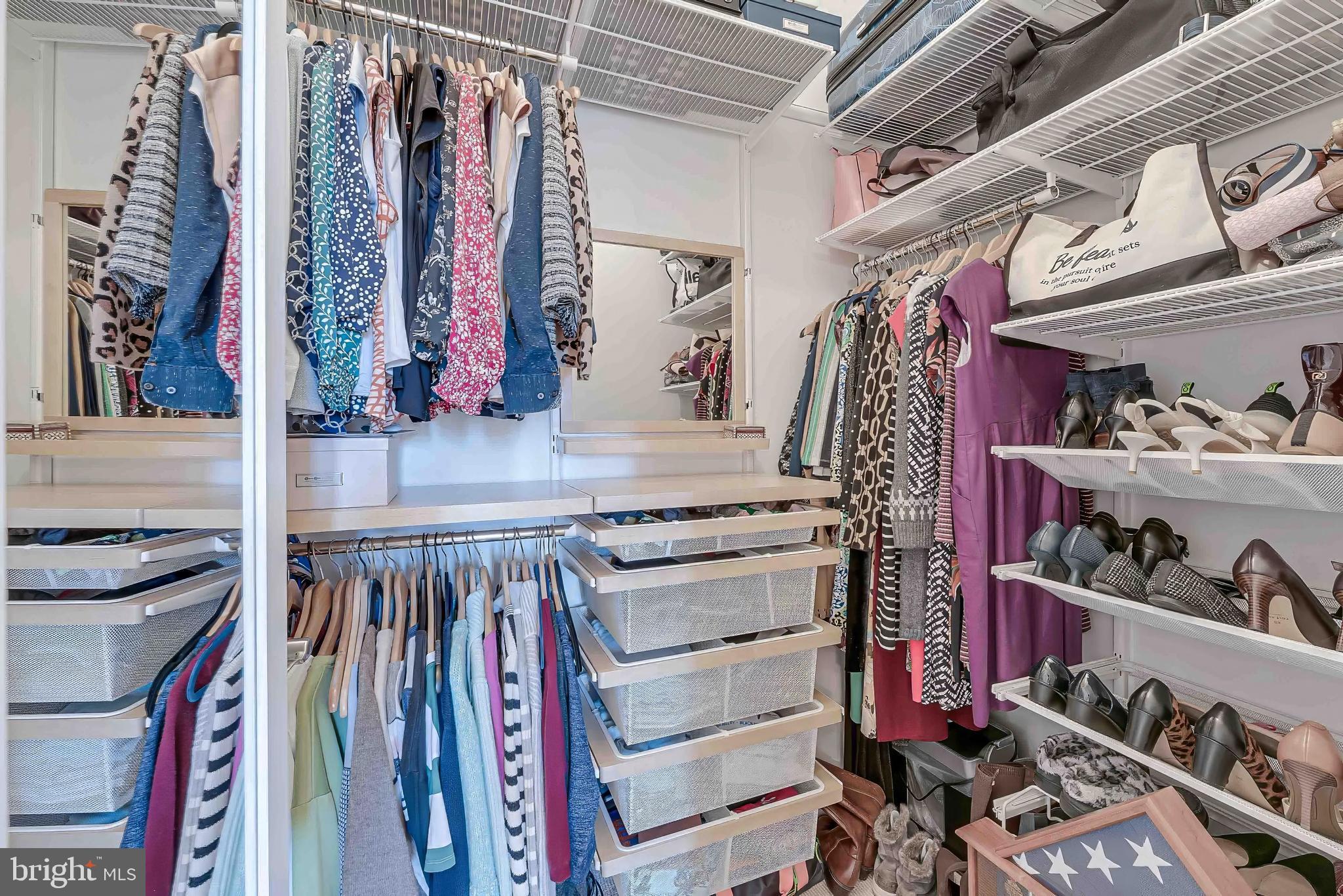 11990 Market Street, Unit 414 Reston, VA 20190 - Photo 33 of 52 a view of walk in closet with clothes and shoes