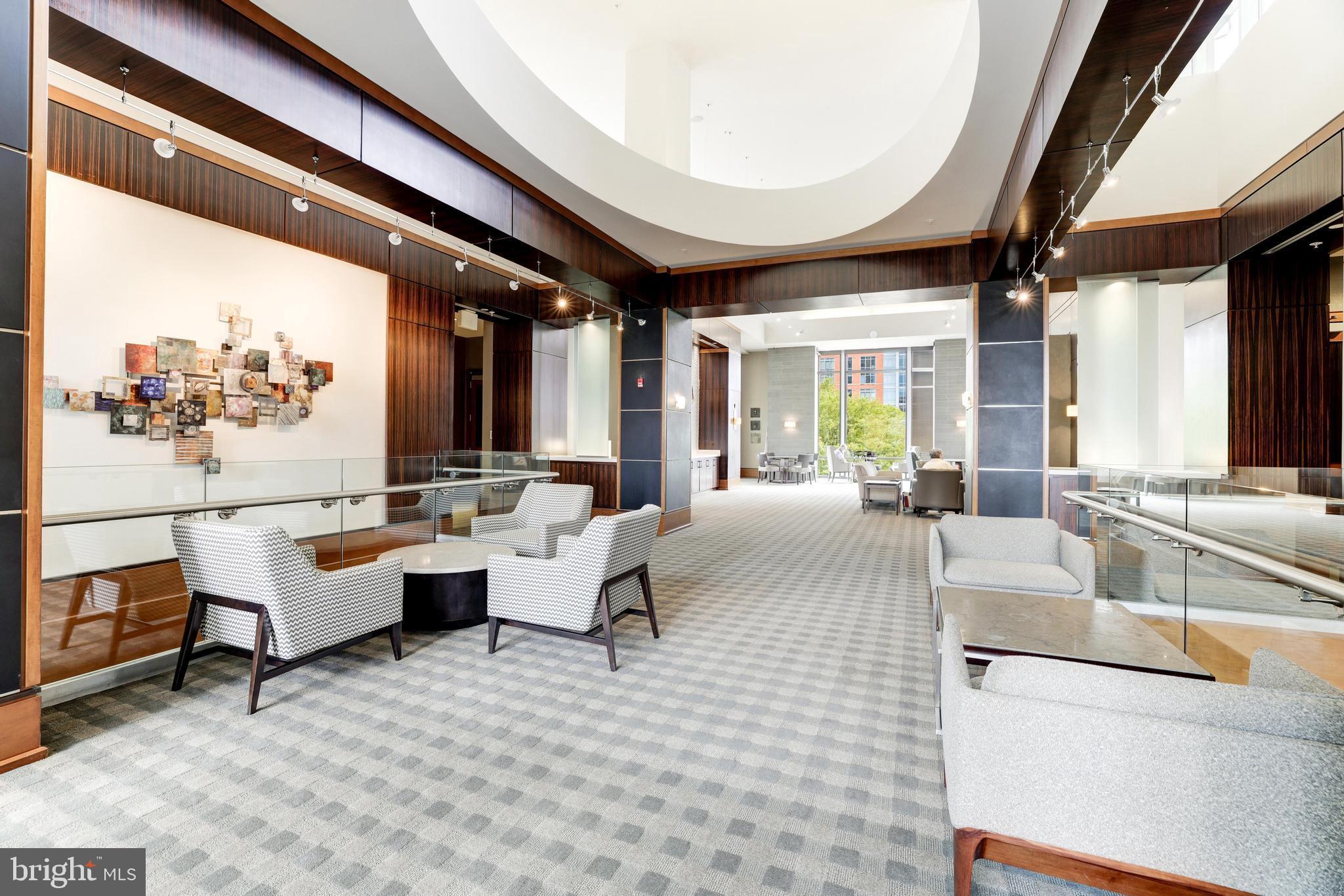 11990 Market Street, Unit 414 Reston, VA 20190 - Photo 39 of 52 a living room with furniture and a large window