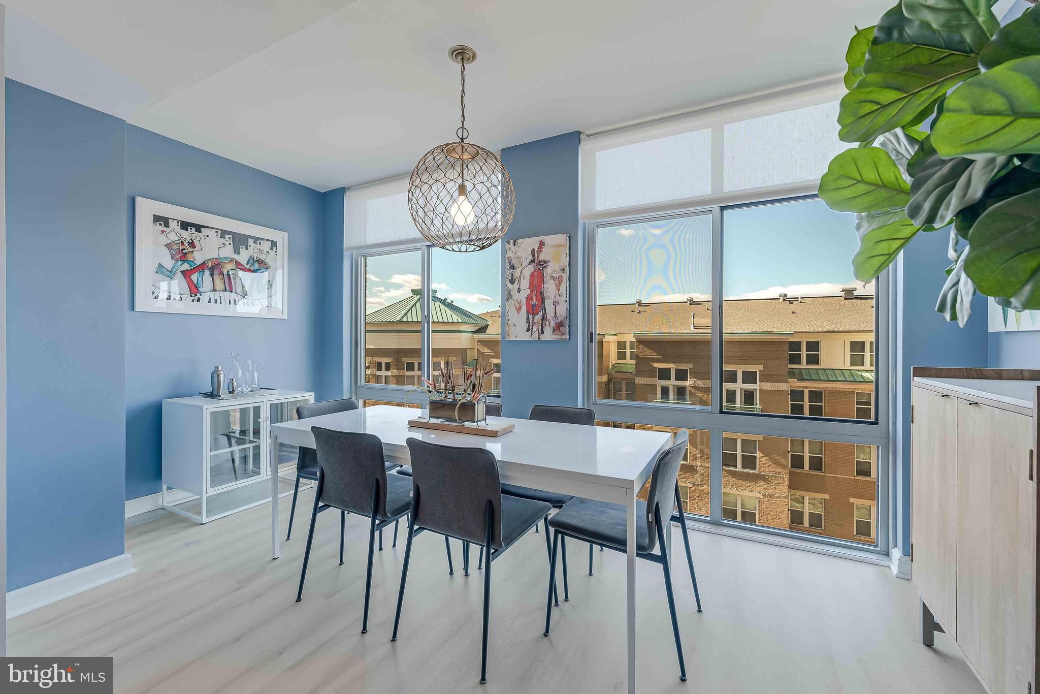 11990 Market Street, Unit 414 Reston, VA 20190 - Photo 4 of 52 a view of a dining room with furniture window and wooden floor