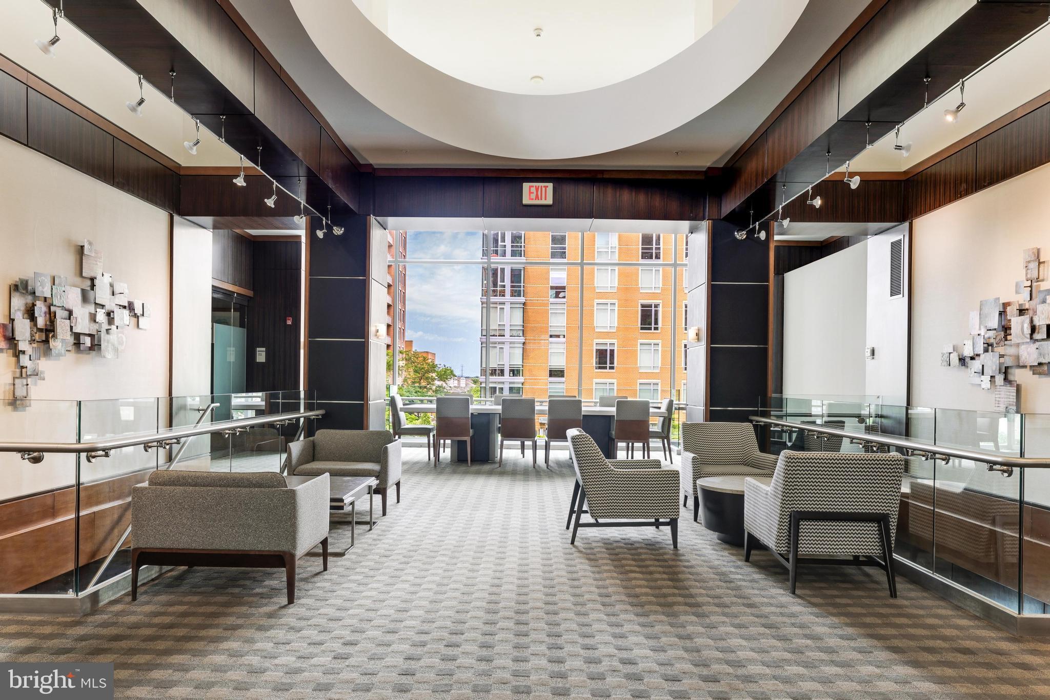 11990 Market Street, Unit 414 Reston, VA 20190 - Photo 41 of 52 a living room with furniture and large windows