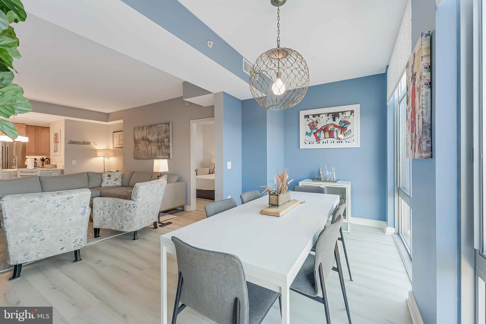 11990 Market Street, Unit 414 Reston, VA 20190 - Photo 8 of 52 a view of a dining room with furniture and chandelier