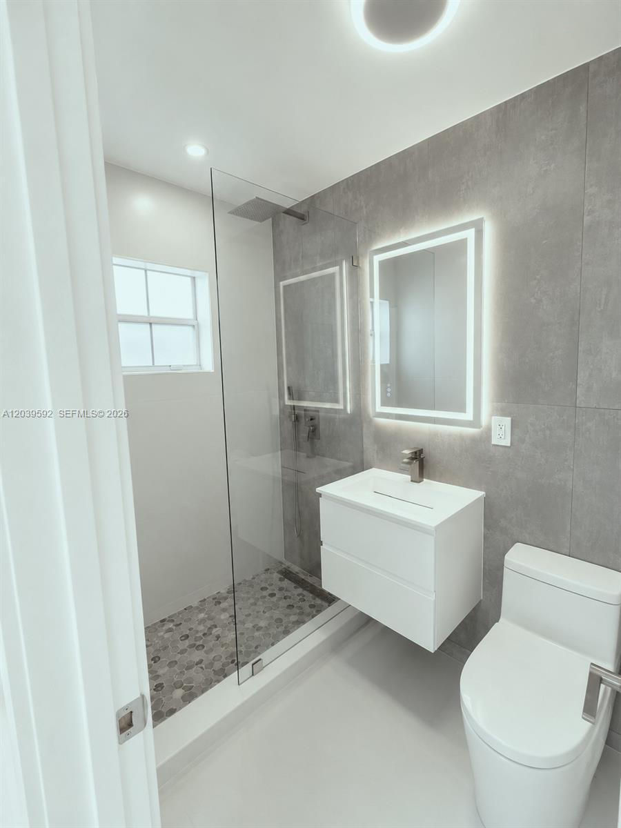 18935 Northwest 8th Avenue Miami Gardens, FL 33169 - Photo 21 of 26 a bathroom with a sink toilet and shower