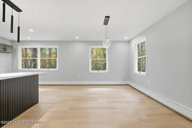 a kitchen with kitchen island stainless steel appliances a sink a counter top space and cabinets