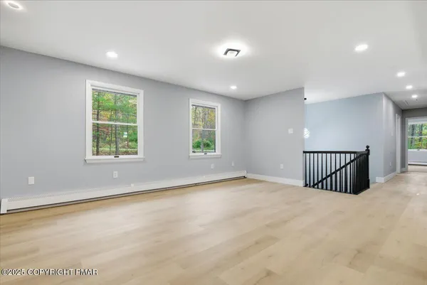 a kitchen with stainless steel appliances granite countertop a sink a stove top oven a refrigerator with wooden cabinets