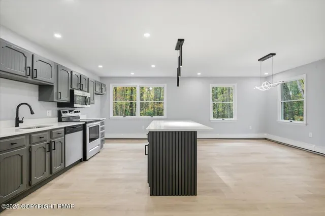 a view of staircase with lots of frames on wall and a window