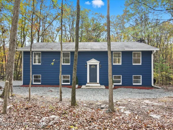 a house that has a tree in front of it