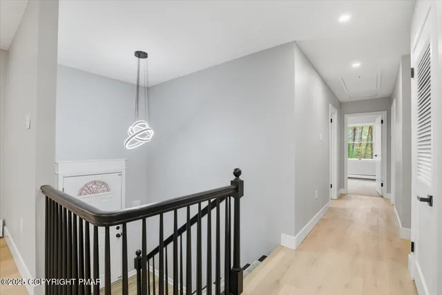 a view of an empty room with a window and fire place