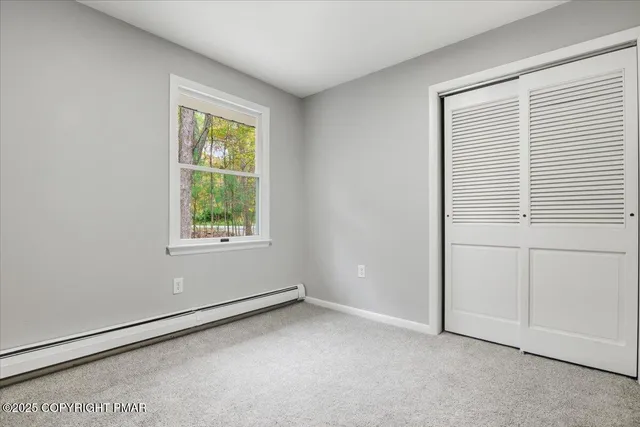a bathroom with a sink a mirror a toilet and a glass door shower