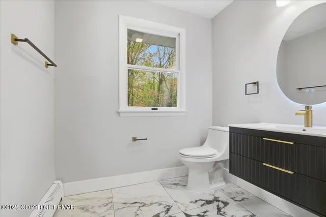 a front view of a house with a tiny tree