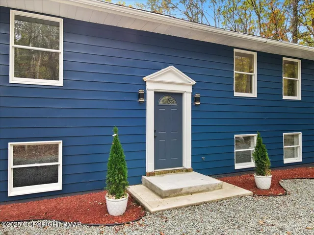 a big room with windows and chandelier