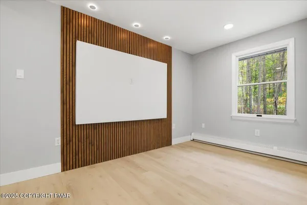 a large kitchen with a large counter top a sink stainless steel appliances and cabinets