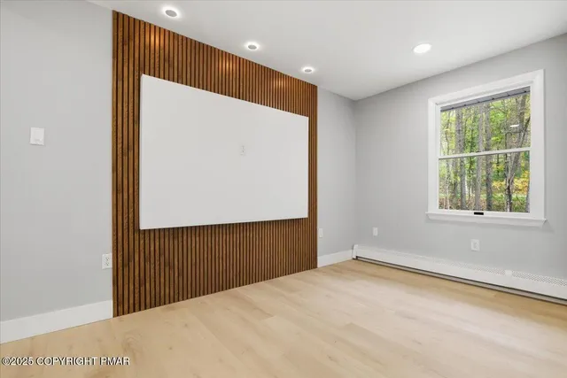 a large kitchen with a large counter top a sink stainless steel appliances and cabinets