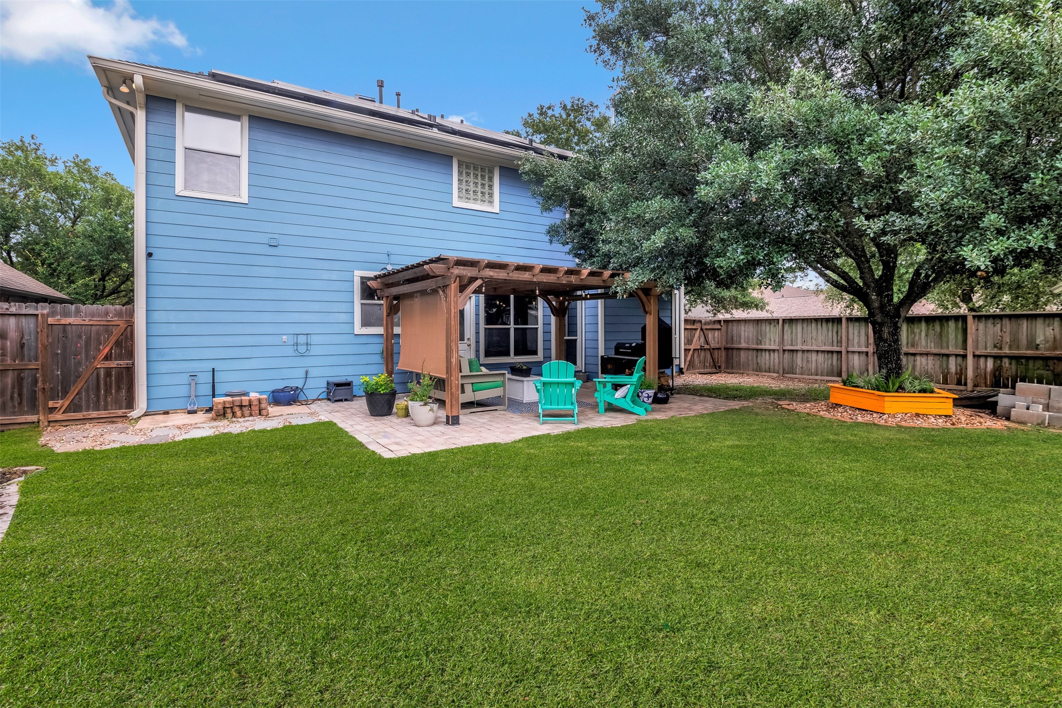 19303 Young Oak Street Spring, TX 77379 - Photo 24 of 29 View of the back elevation of the home. **Grass professionally enhanced**