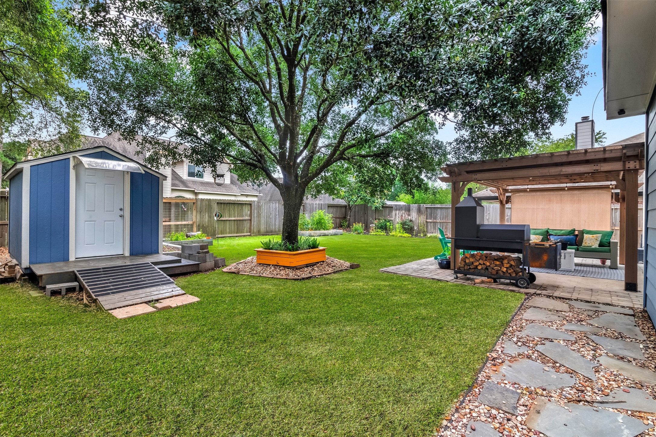 19303 Young Oak Street Spring, TX 77379 - Photo 27 of 29 The spacious backyard has plenty of room for the kids and pets to play and features a shed and large mature trees for plenty of shade. **Grass professionally enhanced**