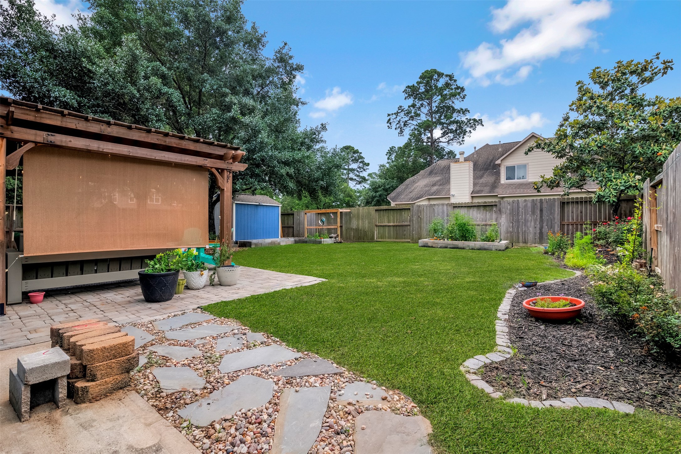 19303 Young Oak Street Spring, TX 77379 - Photo 28 of 29 Another view of the backyard with raised garden and professional landscaping. **Grass professionally enhanced**