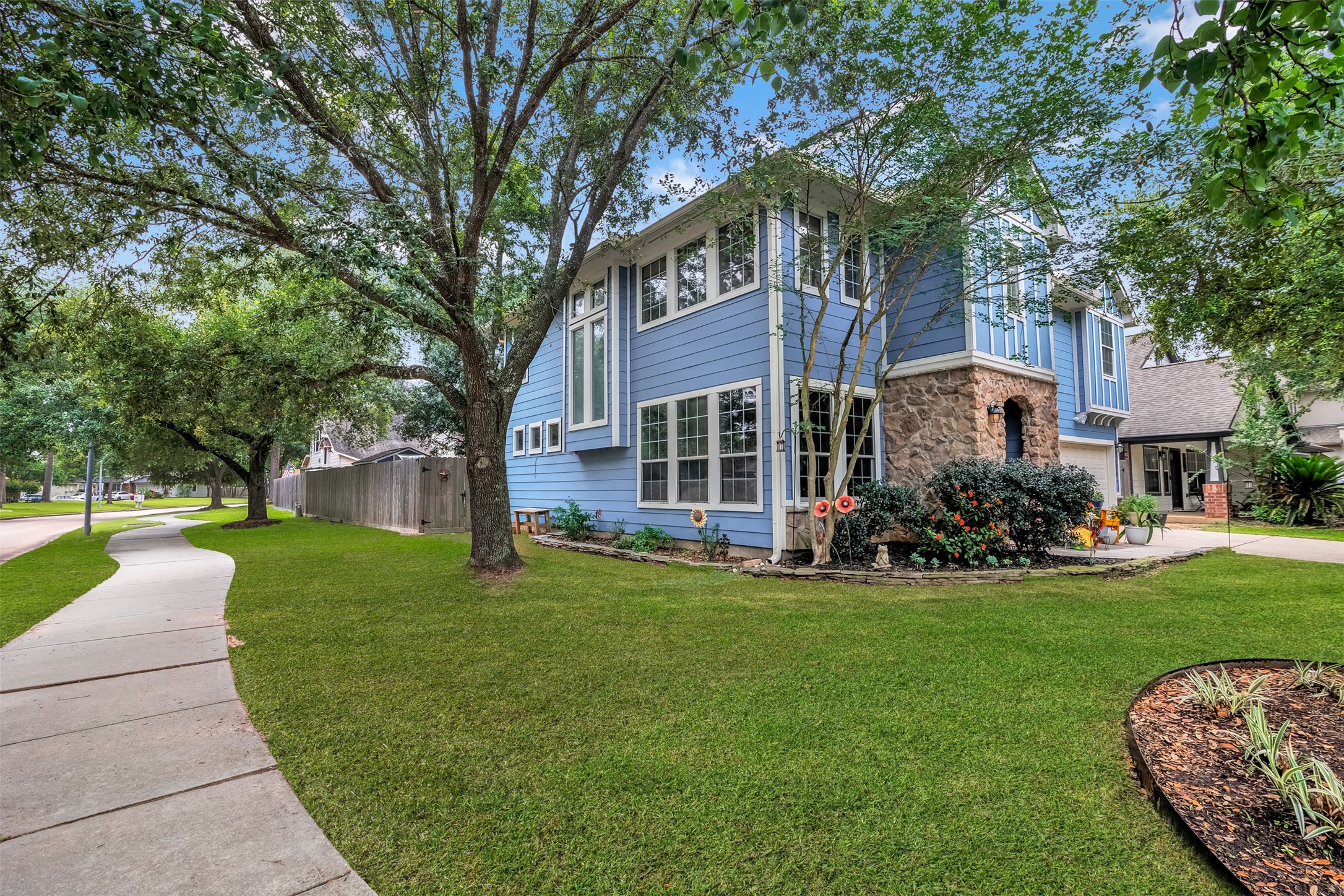 19303 Young Oak Street Spring, TX 77379 - Photo 29 of 29 View of the home on a corner lot with many trees. **Grass professionally enhanced**