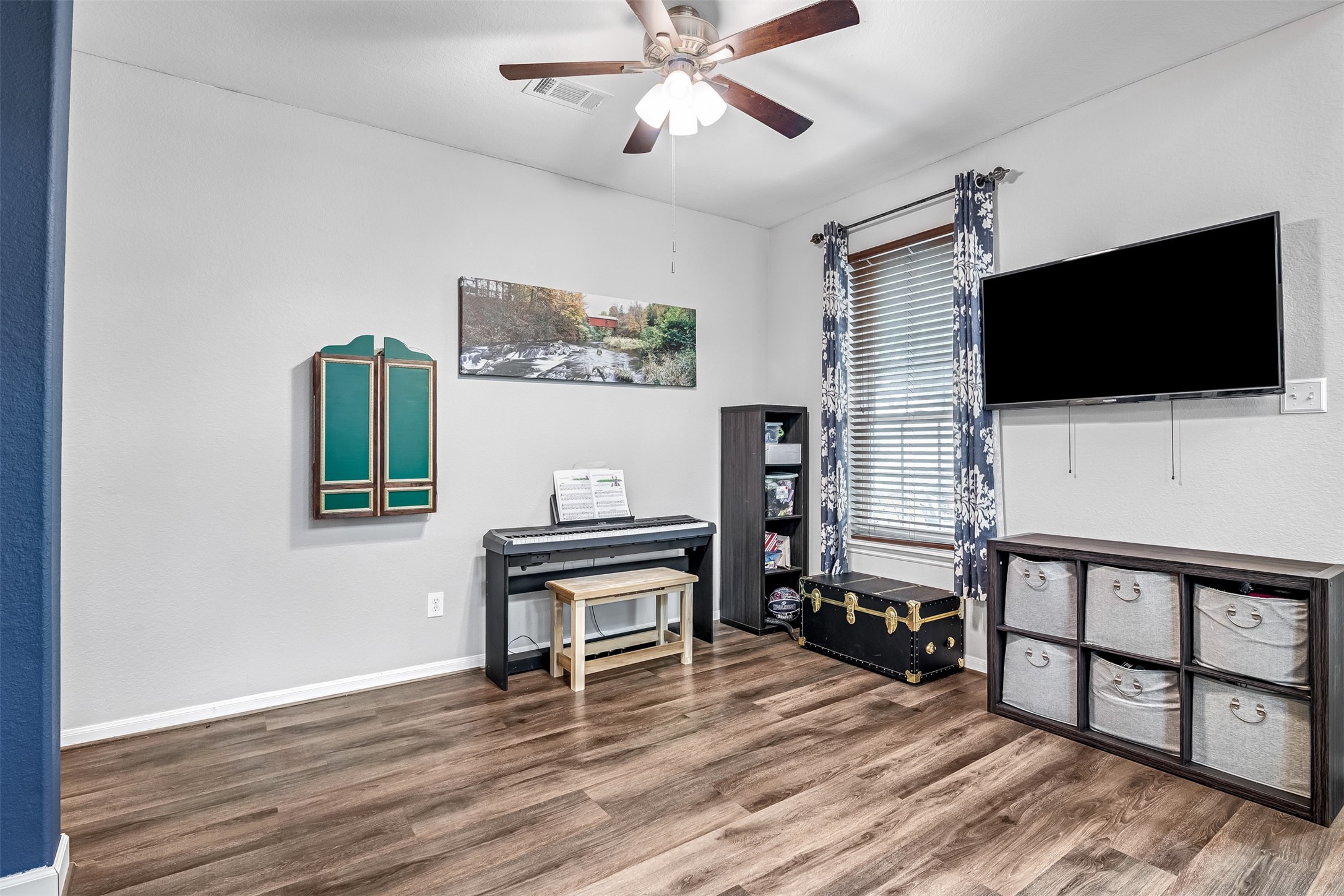 19303 Young Oak Street Spring, TX 77379 - Photo 3 of 29 Just off the front entry to the right is a versatile room that can be used as a dining space or kids play room. It features luxury vinyl flooring, ceiling fan and picture windows.