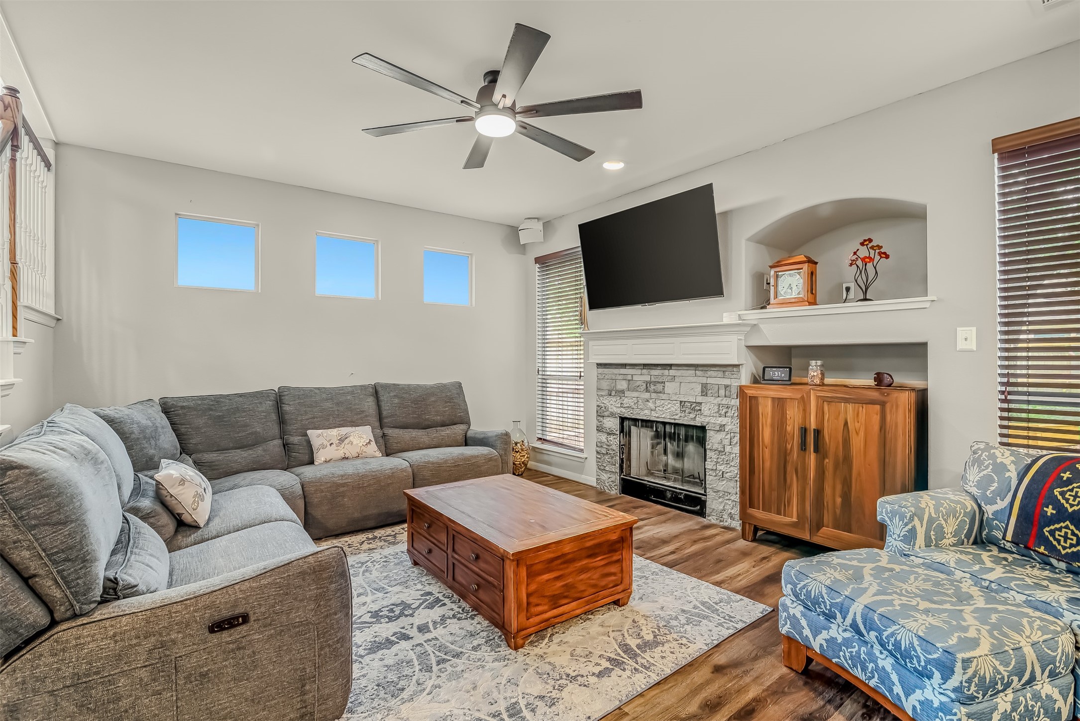 19303 Young Oak Street Spring, TX 77379 - Photo 7 of 29 The family room features an updated ceiling fan, built in niche and fireplace with stone surround and mantle.