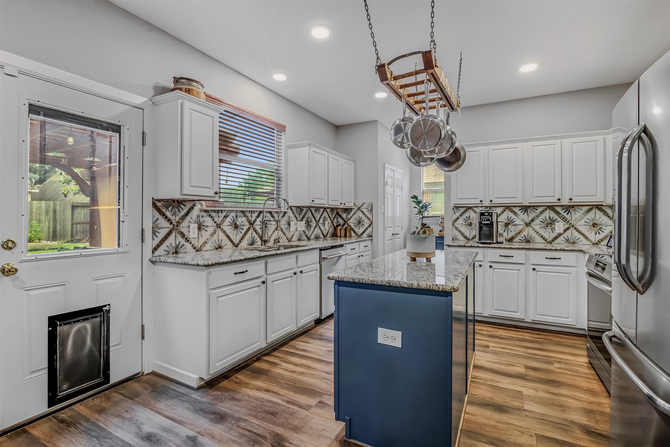 19303 Young Oak Street Spring, TX 77379 - Photo 10 of 29 The kitchen features a large island with storage and pan rack above.