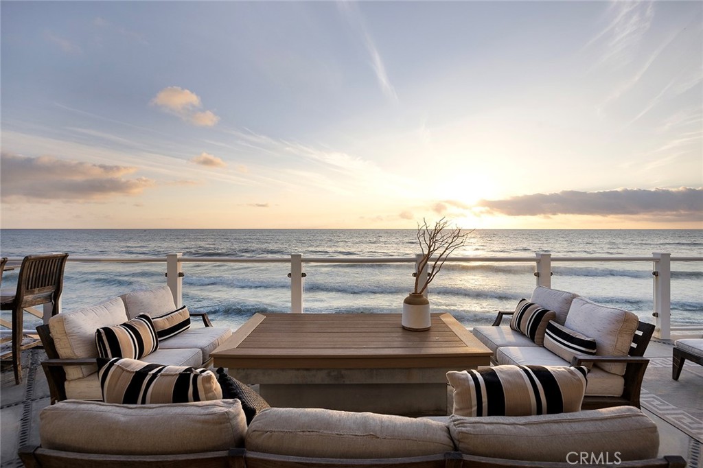 a view of roof deck with furniture and city view