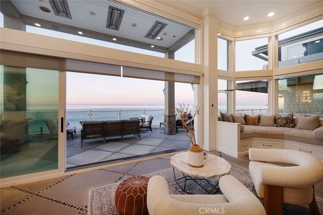 a living room with furniture and a floor to ceiling window