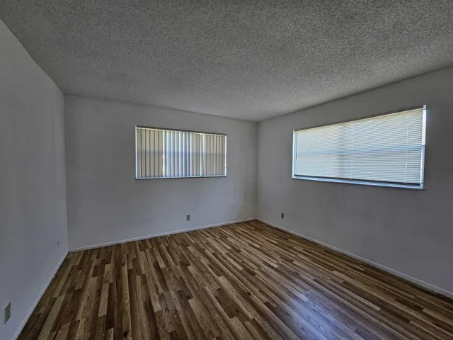 a view of a room with wooden floor and windows