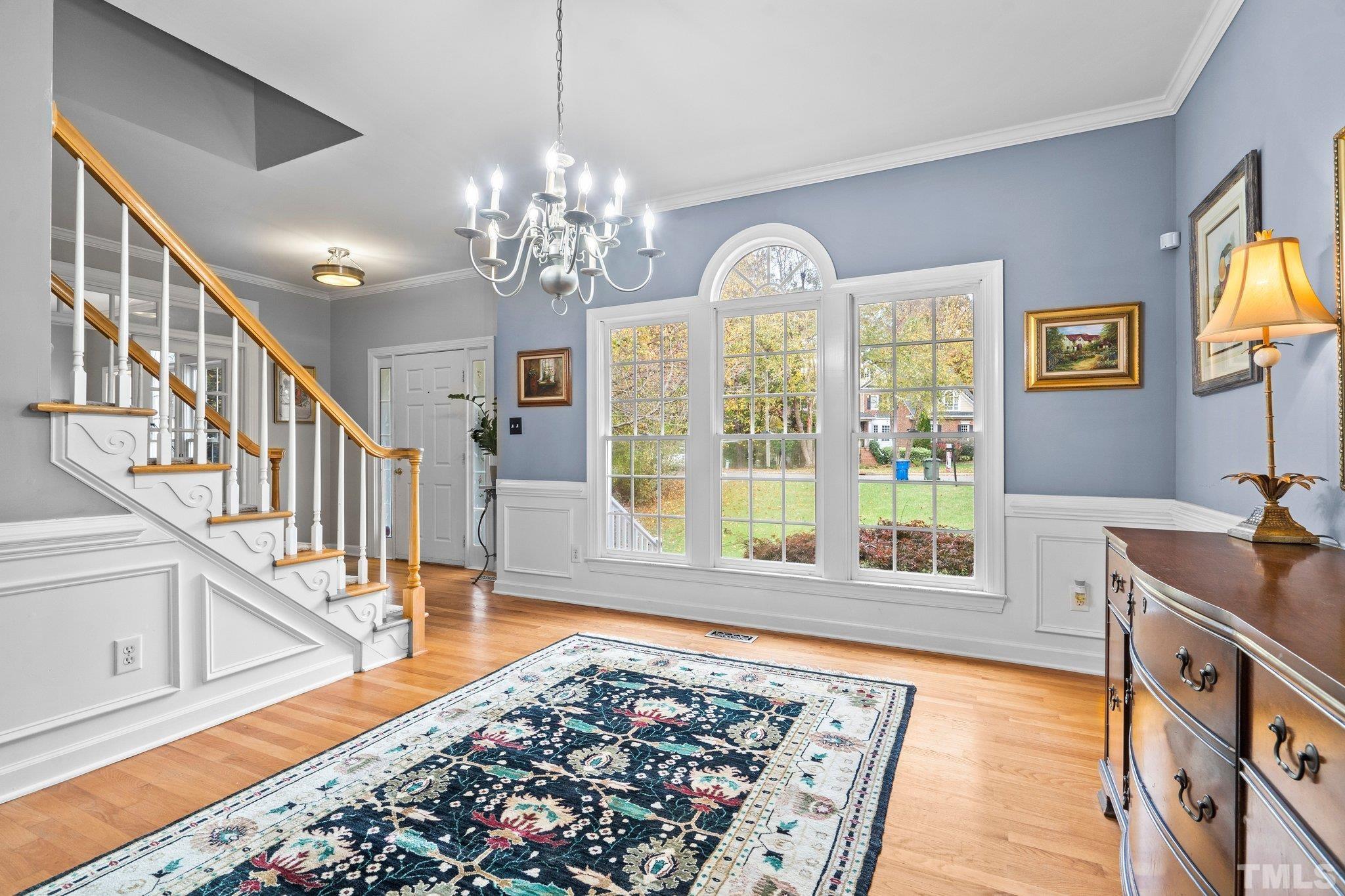 1508 October Road Raleigh, NC 27614 - Photo 7 of 30 a view of an entryway with wooden floor and chandelier