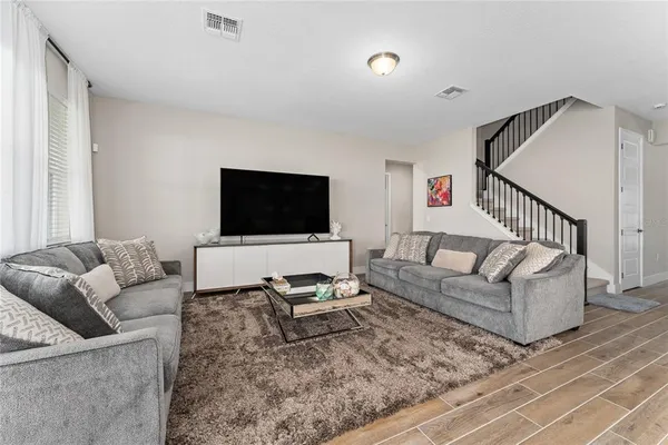 a living room with furniture and a flat screen tv
