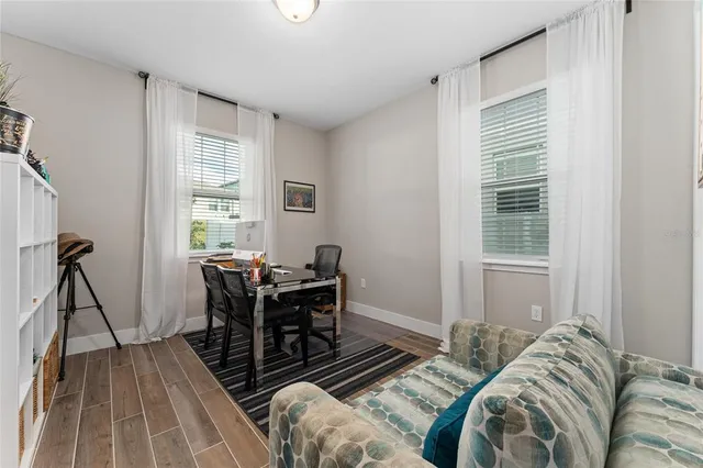 a view of a livingroom with furniture and a window