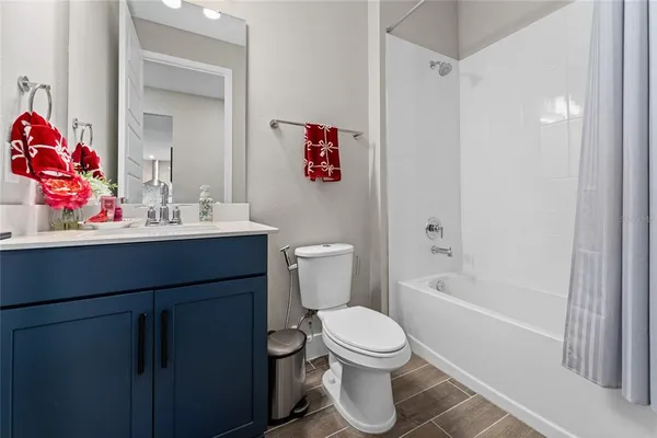 a bathroom with a sink mirror vanity and toilet