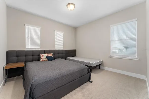 a bedroom with bed and window