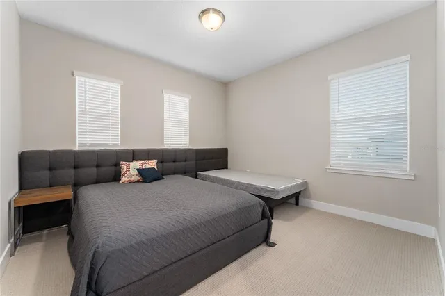 a bedroom with bed and window