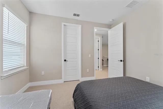 a bedroom with a bed and a couch