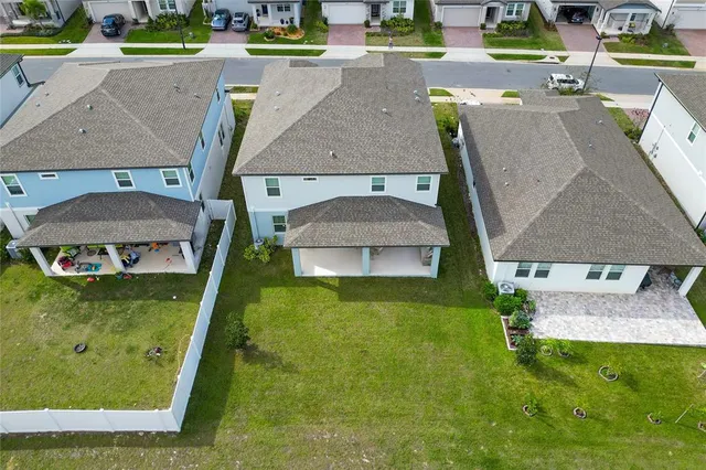 an aerial view of a house with outdoor space